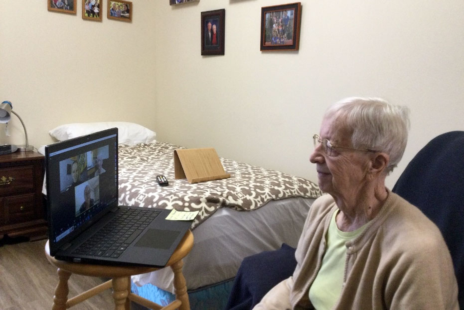 Woman speaks with students on virtual village meeting