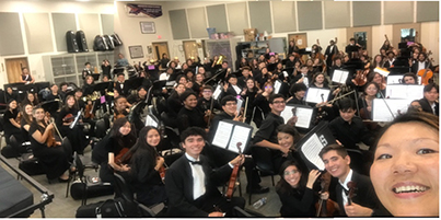 Kira Omelchenko posing with room full of musicians