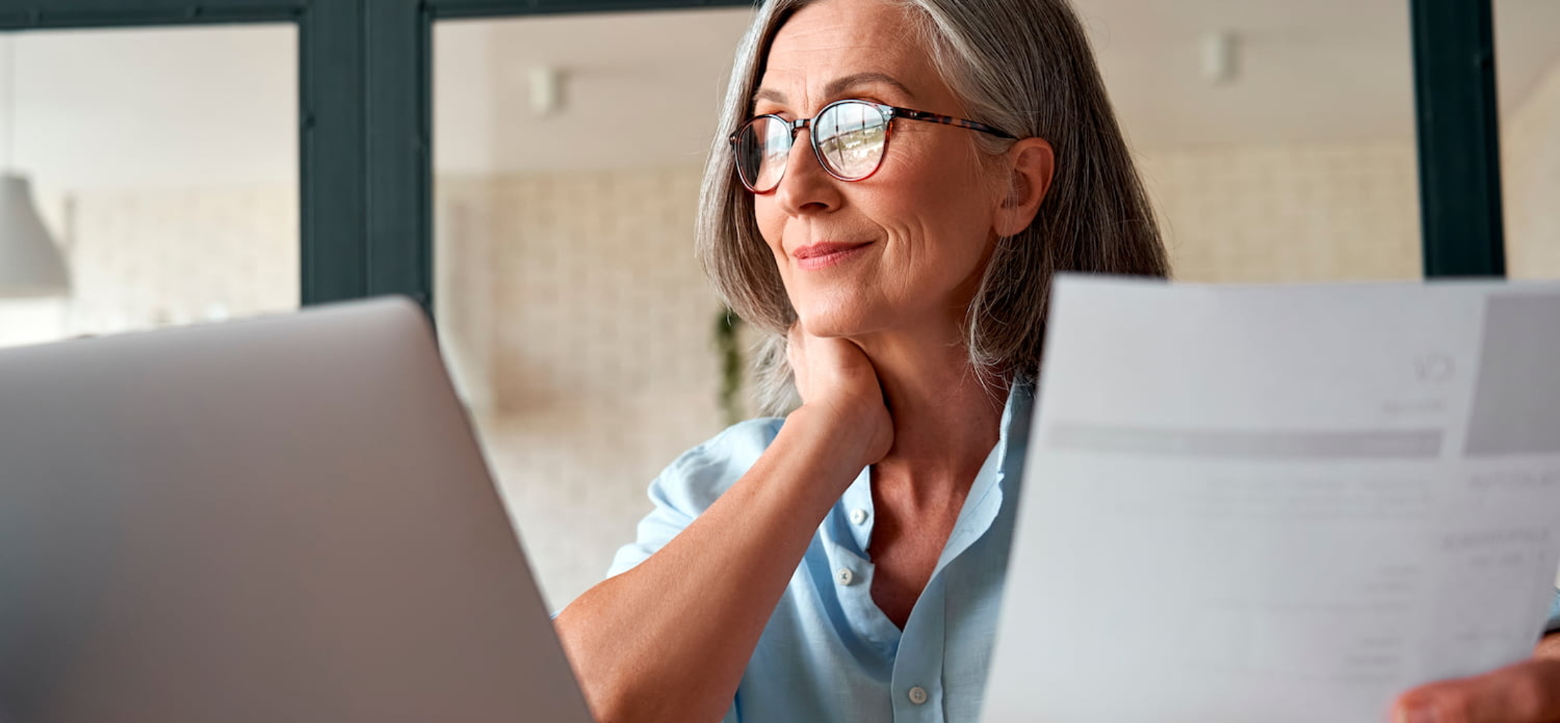 mature female working at a laptop at home