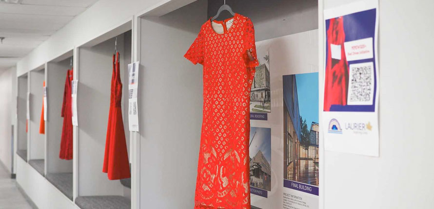 Red dresses hanging in a hallway