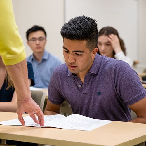 student reading at desk