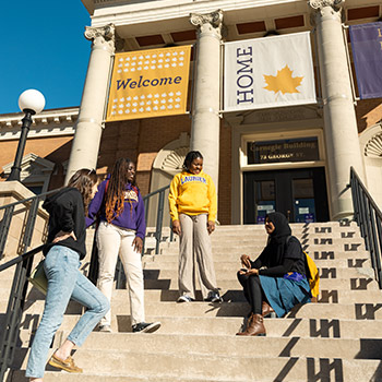 four female students sitting outside of carnergie