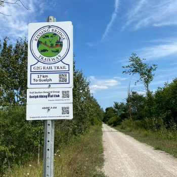 sign next to a dirt path