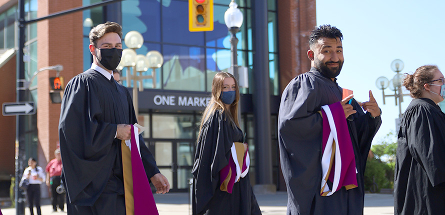 Graduands walking and smiling