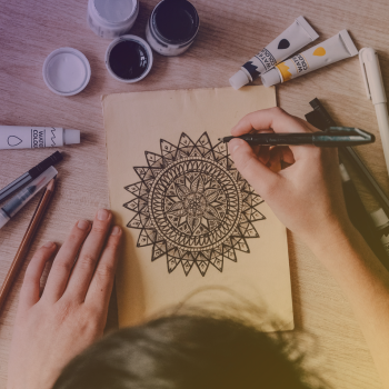 hand colouring a mandala on paper