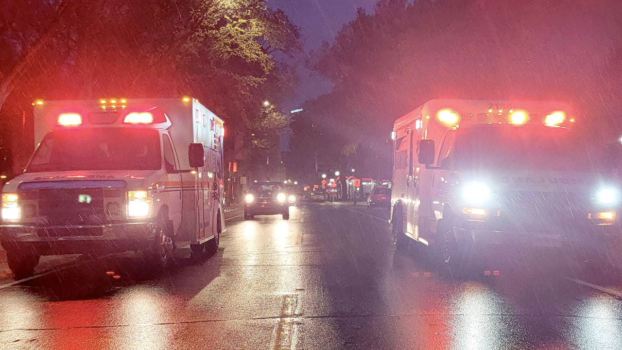 Paramedics help person on the ground